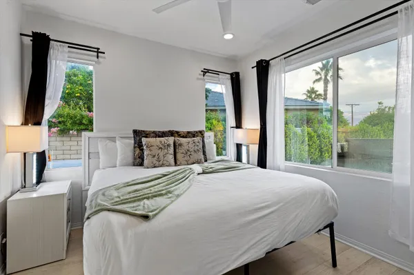a bedroom with a bed and a window