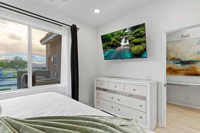 a bedroom with a bed and a window