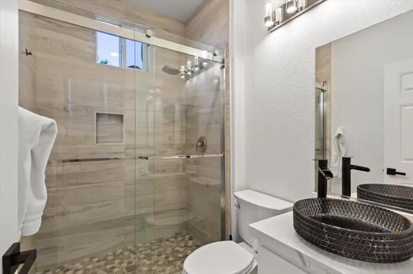 a bathroom with a toilet and a shower
