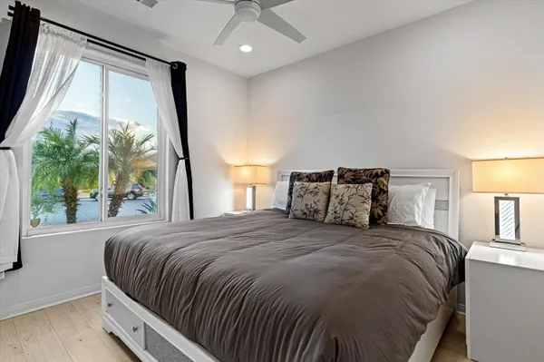 a bedroom with a large bed and a large window