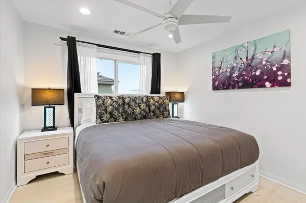 a bedroom with a large bed and a window