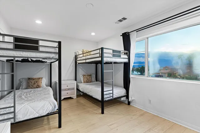 a bedroom with furniture and a window