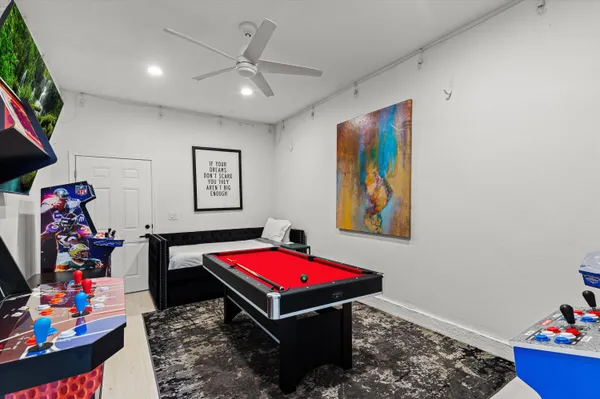 a living room with furniture and air hockey table