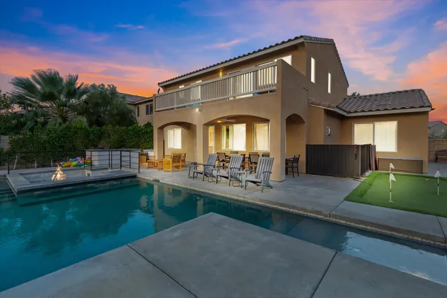 a view of a house with pool table and chairs