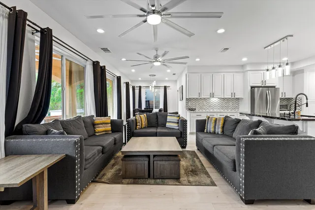 a living room with furniture and a large window