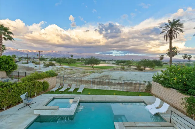 a front view of house with a garden