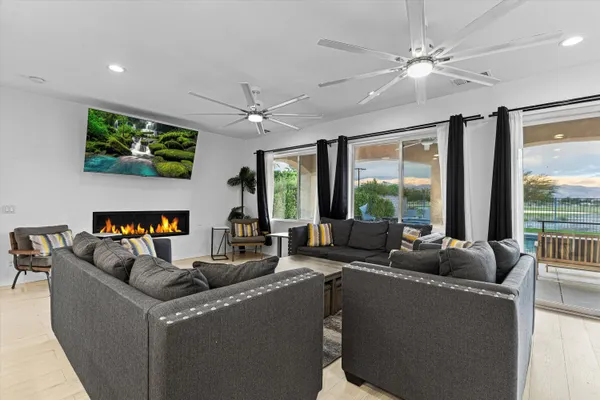 a living room with furniture a fireplace and a flat screen tv