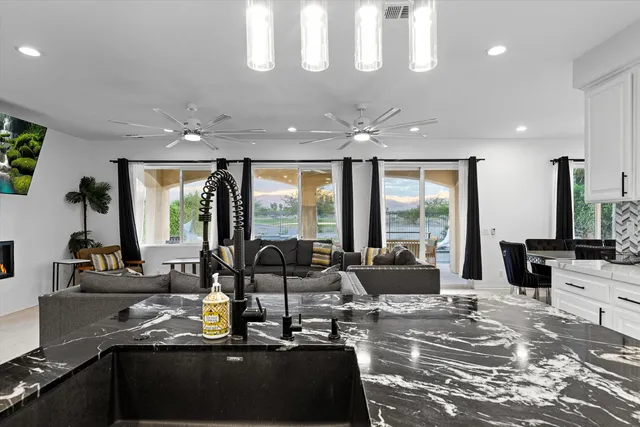 a view of a livingroom with furniture and large windows