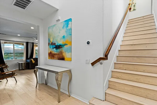 a view of entryway and hall with wooden floor