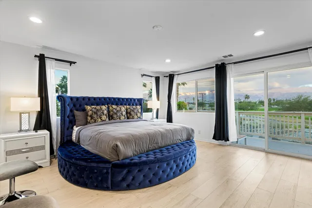 a bedroom with a large bed and a large window