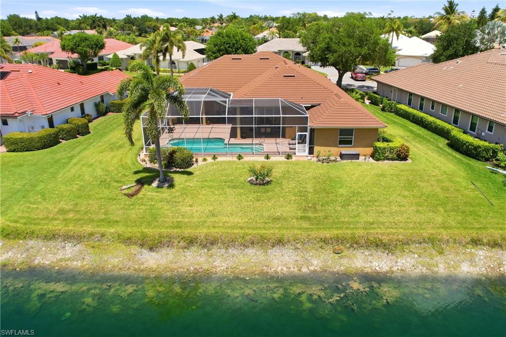 10815 Phoenix Way Naples, FL 34119 - Photo 28 of 40 a view of house with garden space and swimming pool
