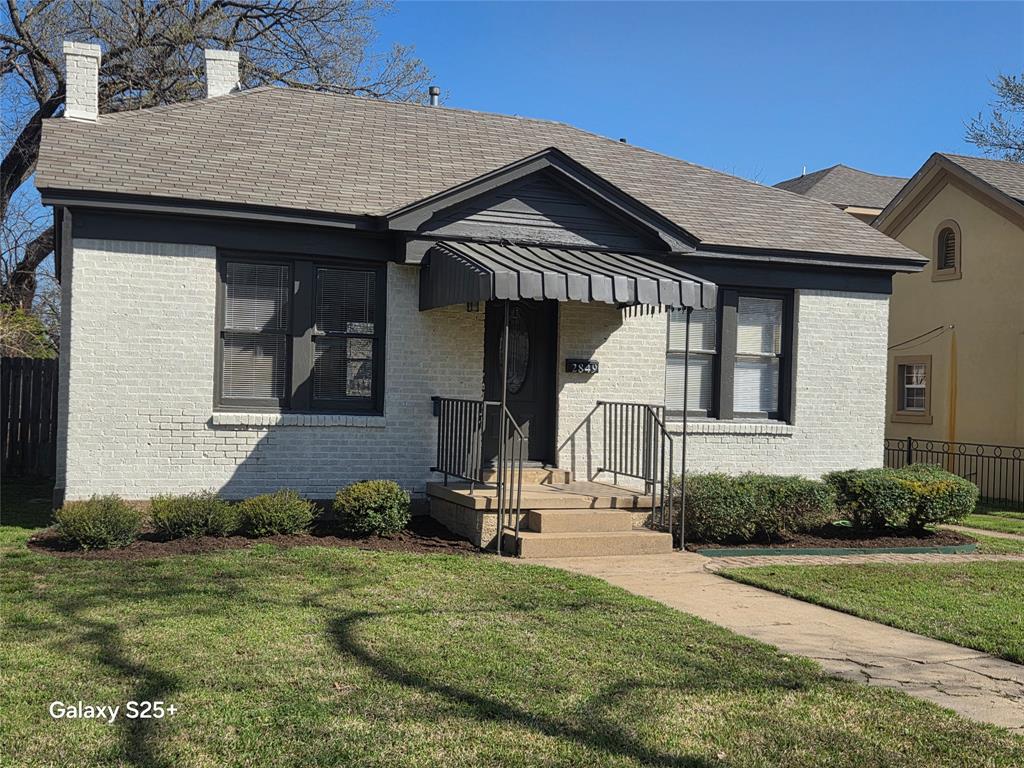 2849 West 12th Street Dallas, TX 75211 - Photo 1 of 14 a front view of a house with a yard