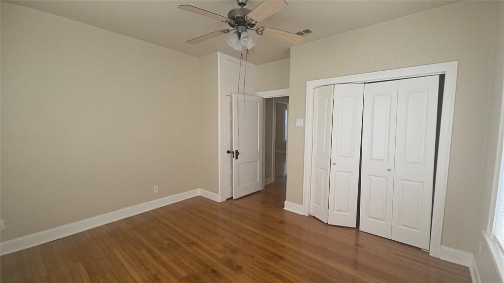 2849 West 12th Street Dallas, TX 75211 - Photo 11 of 14 a view of an empty room with wooden floor
