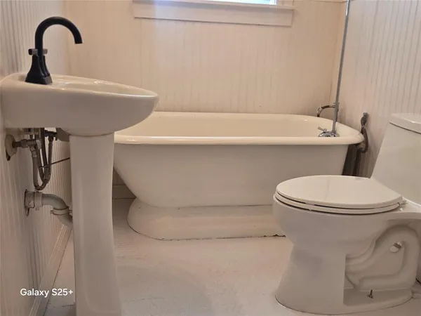 a bathroom with a toilet and a sink