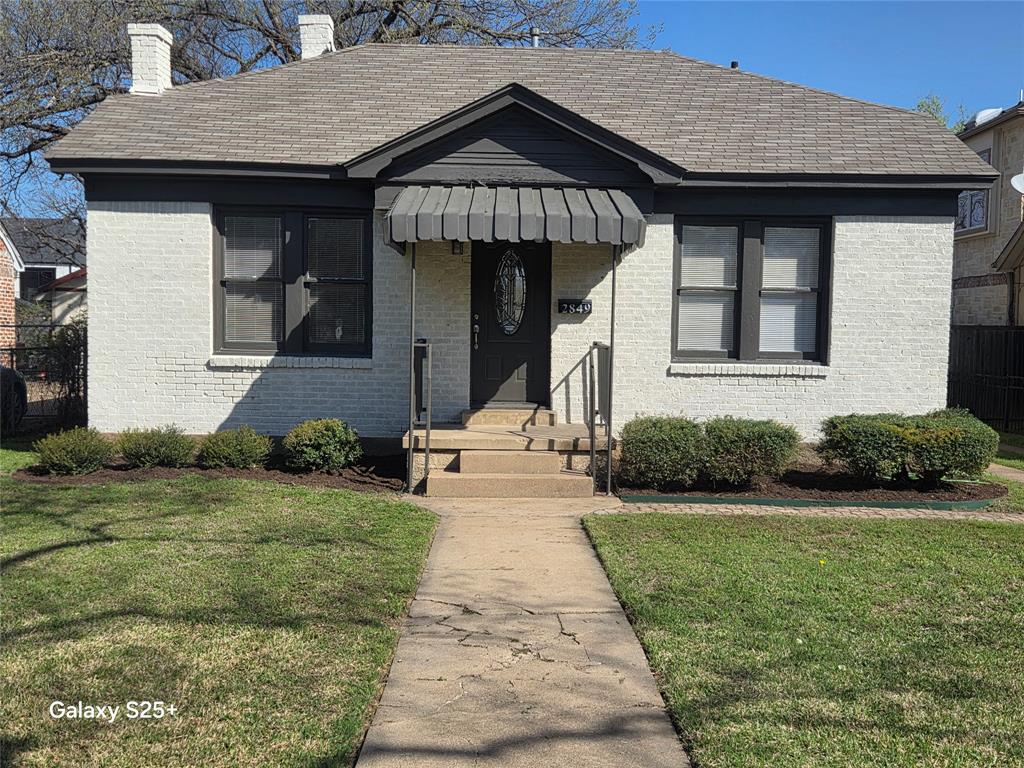2849 West 12th Street Dallas, TX 75211 - Photo 2 of 14 a front view of a house with a yard