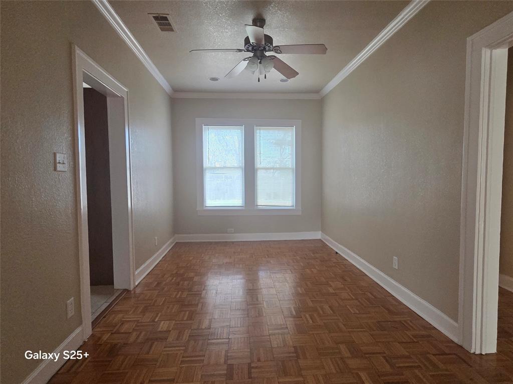 2849 West 12th Street Dallas, TX 75211 - Photo 5 of 14 a view of empty room with window and a ceiling fan