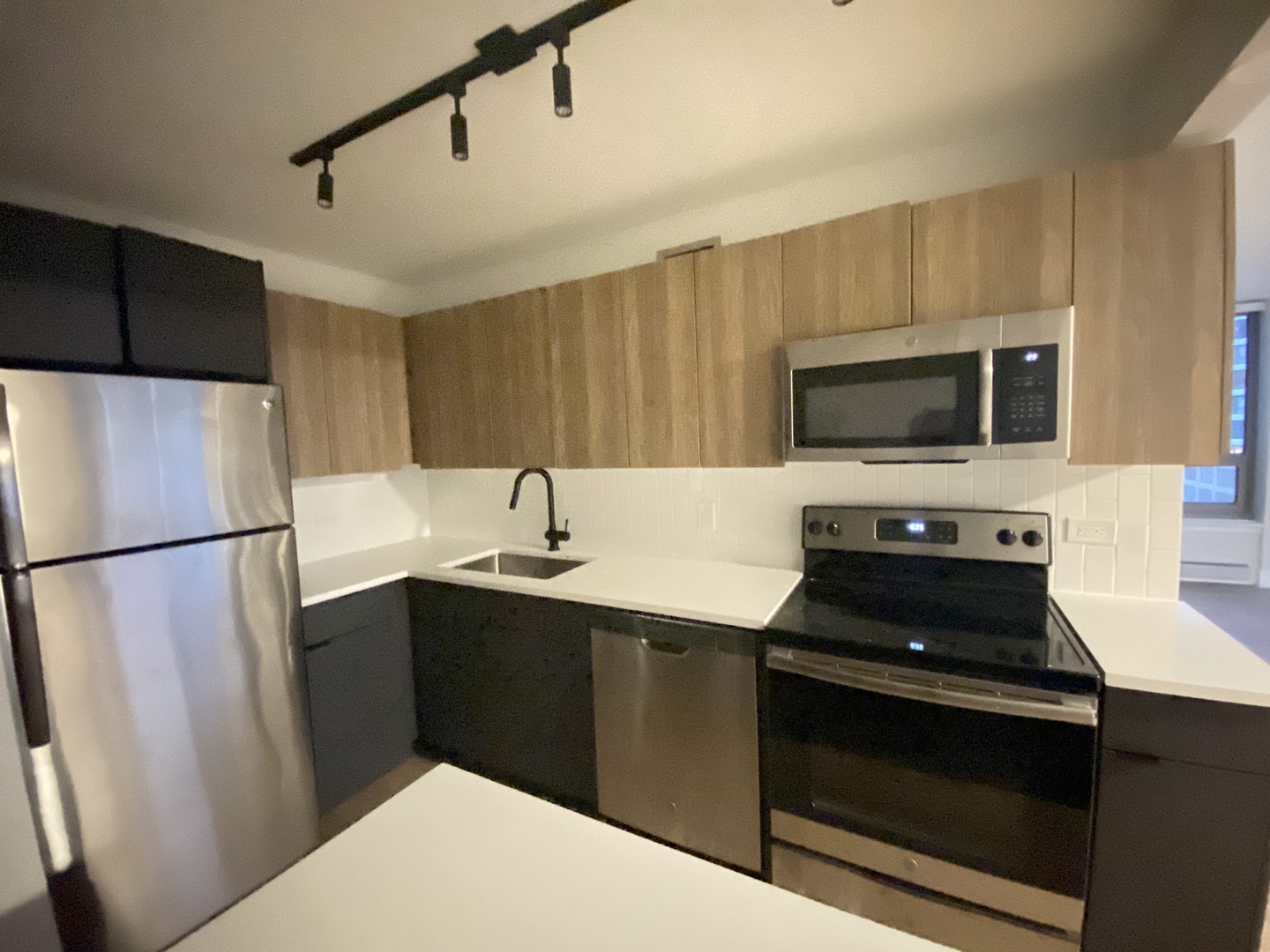Undisclosed Address Chicago, IL 60611 - Photo 4 of 15 a kitchen with a sink a stove and refrigerator