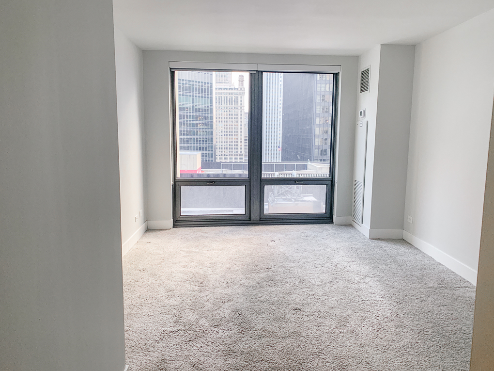 Undisclosed Address Chicago, IL 60611 - Photo 6 of 15 a view of an empty room with a window