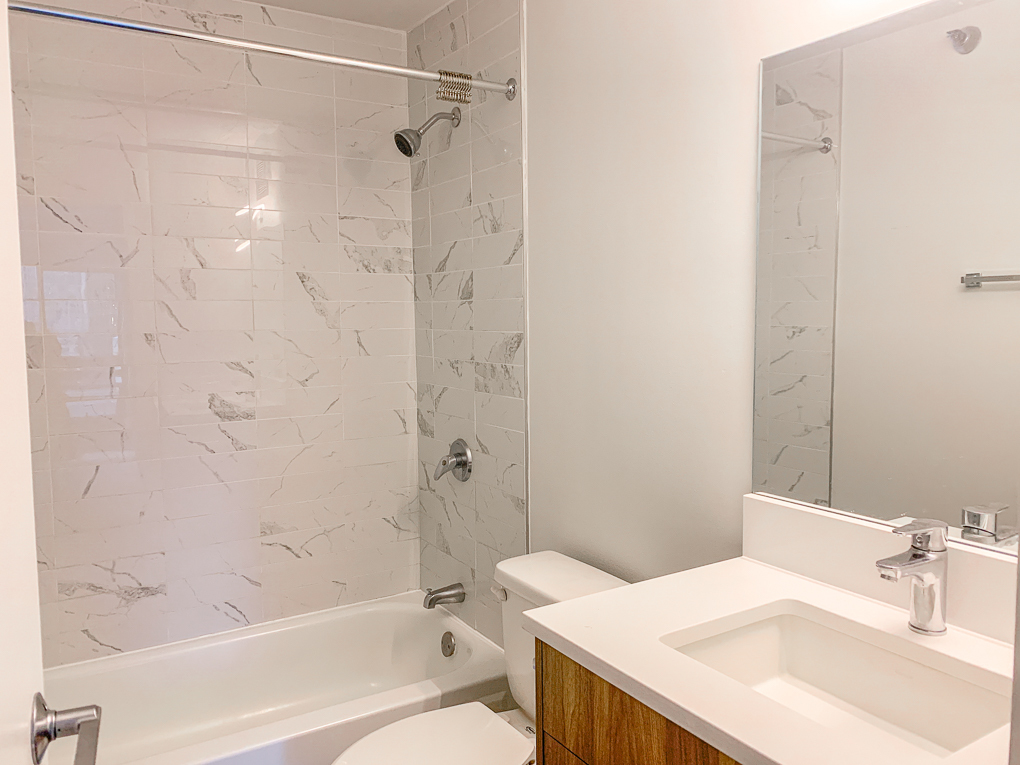 Undisclosed Address Chicago, IL 60611 - Photo 8 of 15 a bathroom with a sink a toilet and shower