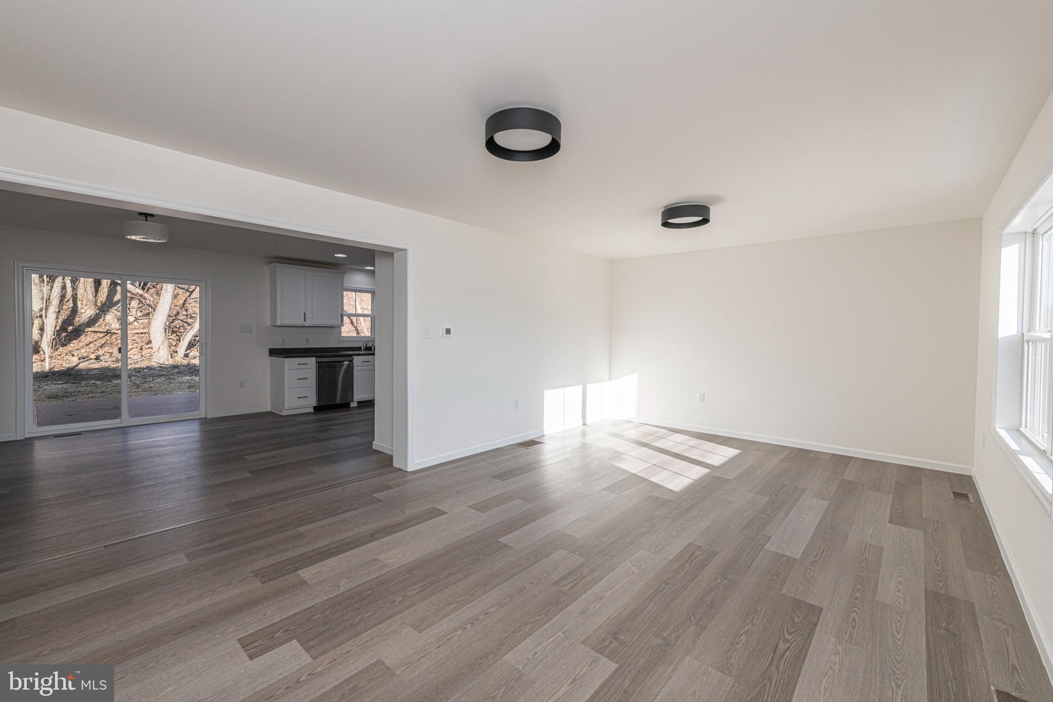 617 Port Providence Road Phoenixville, PA 19460 - Photo 5 of 25 an empty room with wooden floor and windows
