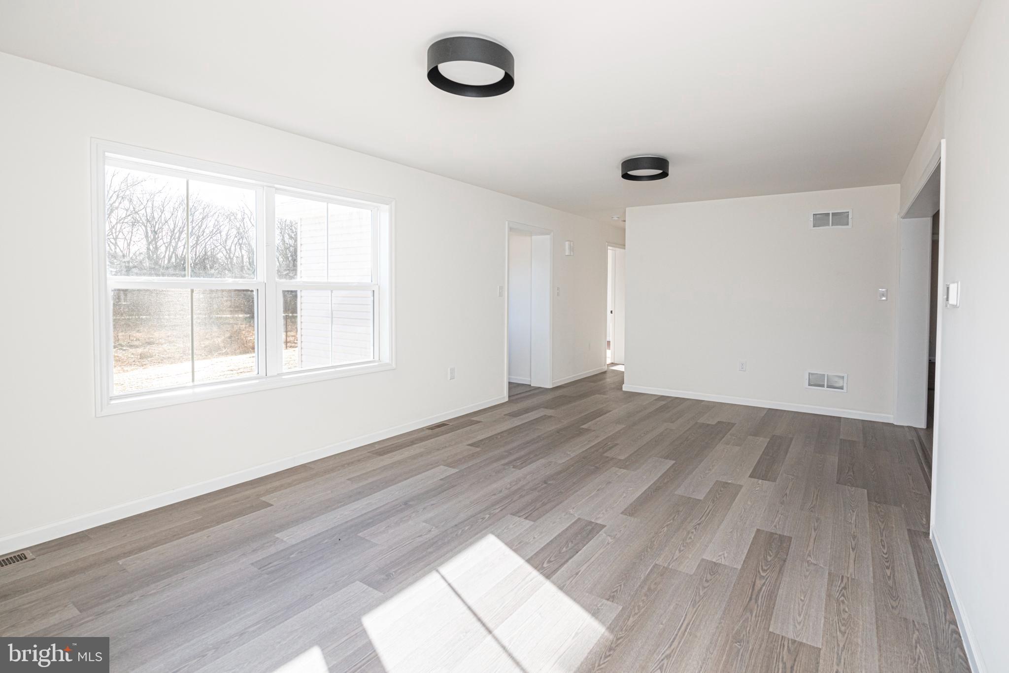 617 Port Providence Road Phoenixville, PA 19460 - Photo 6 of 25 an empty room with wooden floor and windows