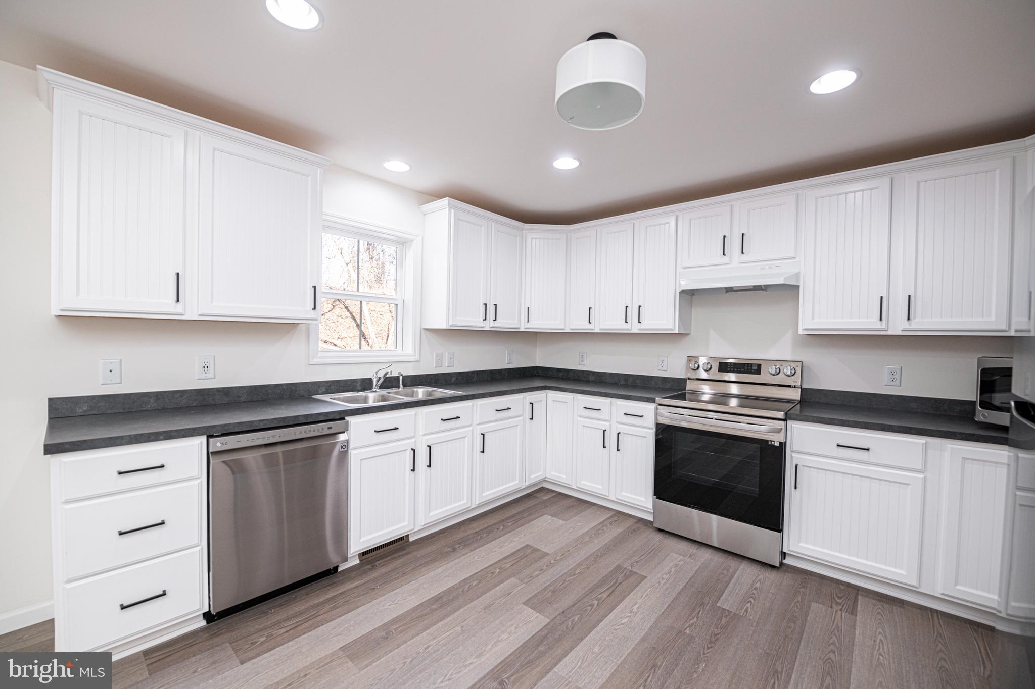 617 Port Providence Road Phoenixville, PA 19460 - Photo 8 of 25 a kitchen with granite countertop white cabinets and white appliances
