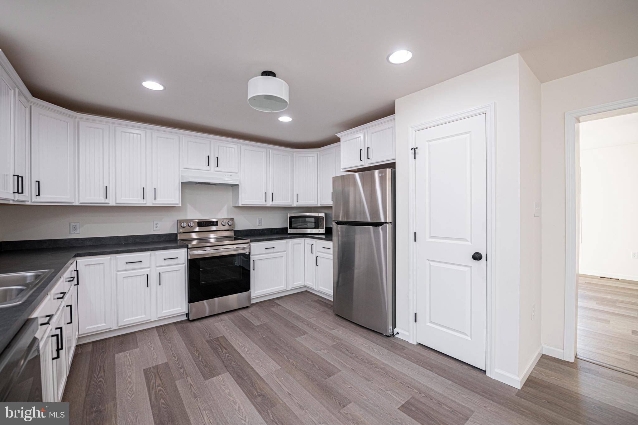 617 Port Providence Road Phoenixville, PA 19460 - Photo 9 of 25 a kitchen with granite countertop a refrigerator stove top oven and sink