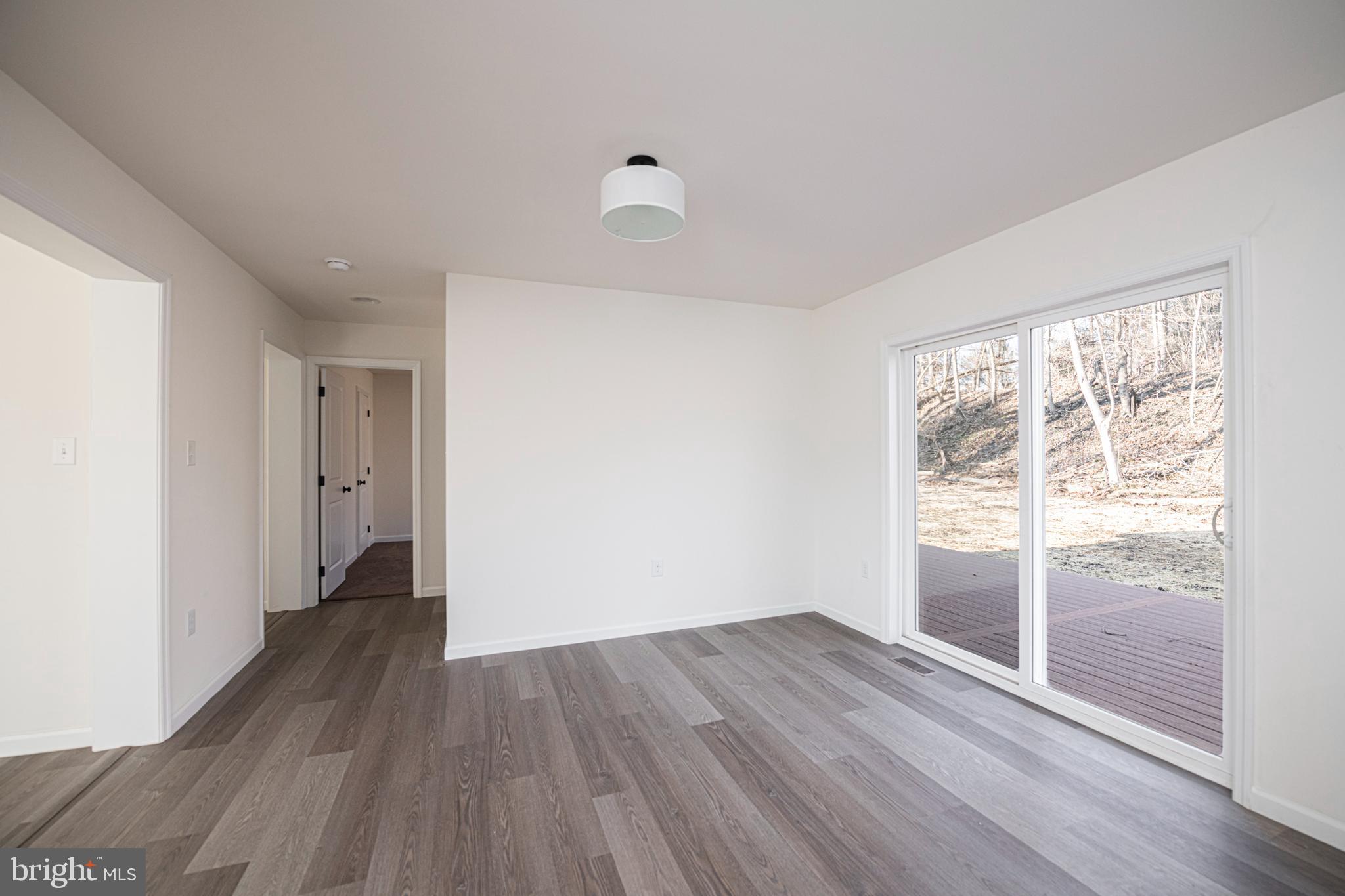 617 Port Providence Road Phoenixville, PA 19460 - Photo 10 of 25 an empty room with wooden floor and windows