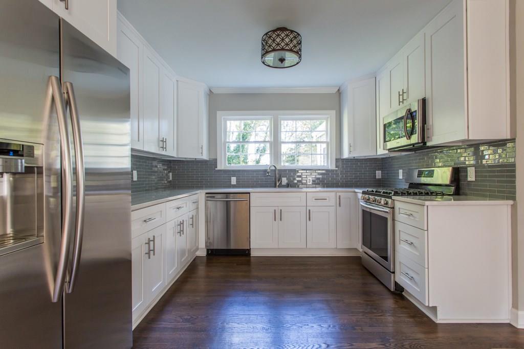 2013 Neely Avenue East Point, GA 30344 - Photo 1 of 1 a kitchen with stainless steel appliances granite countertop a stove a sink and a refrigerator
