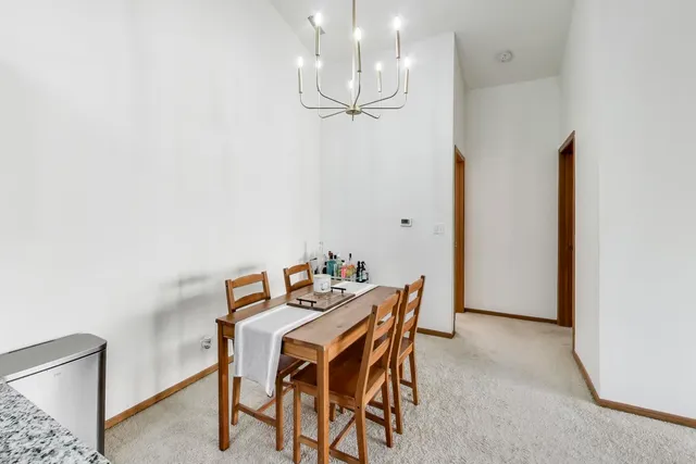 a view of a dining room with furniture and chandelier