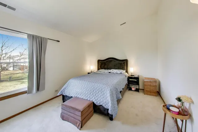 a bedroom with a bed and window