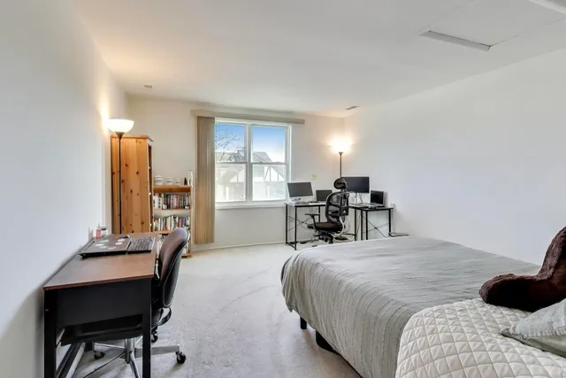 a bed room with a bed and a chair