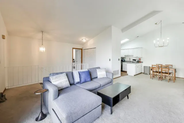 a living room with furniture and kitchen view