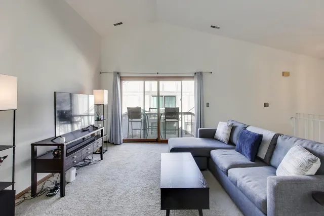 a living room with furniture gym equipment and a large window