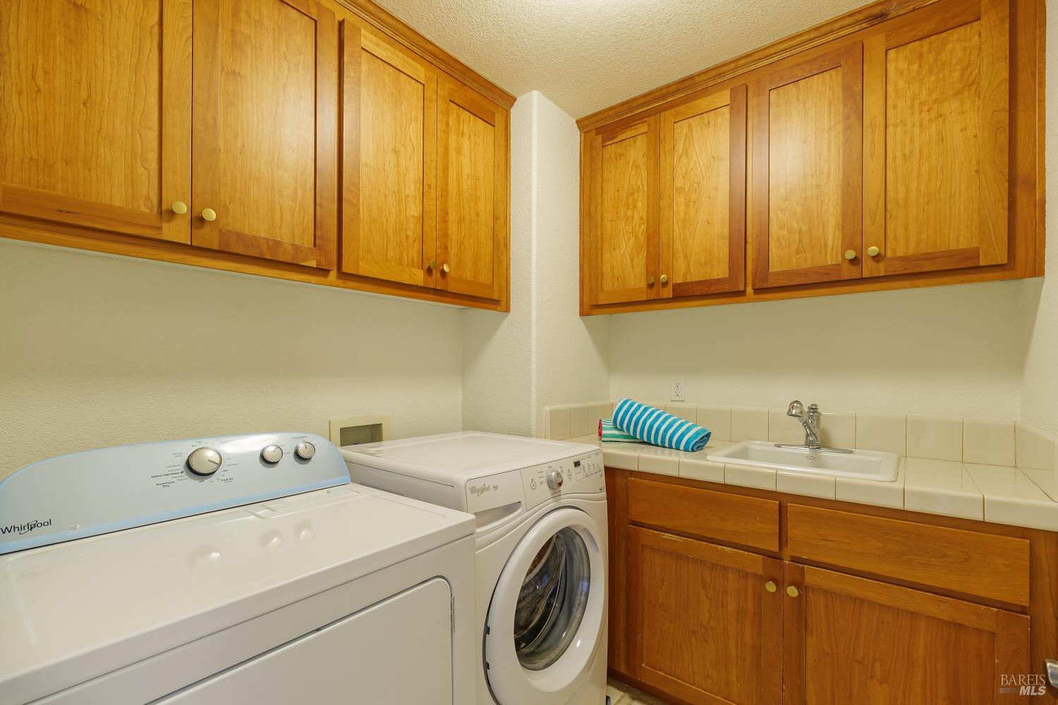 68 Pinheiro Circle Novato, CA 94945 - Photo 59 of 82 The dedicated laundry room is thoughtfully designed with abundant cabinetry, a utility sink, generous counter space for folding, and extra storage to keep everyday tasks organized and efficient.