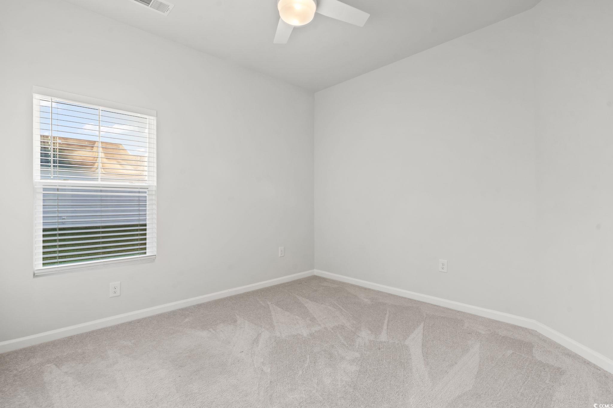 229 Cypress Tree Loop Longs, SC 29568 - Photo 12 of 40 Carpeted empty room with ceiling fan