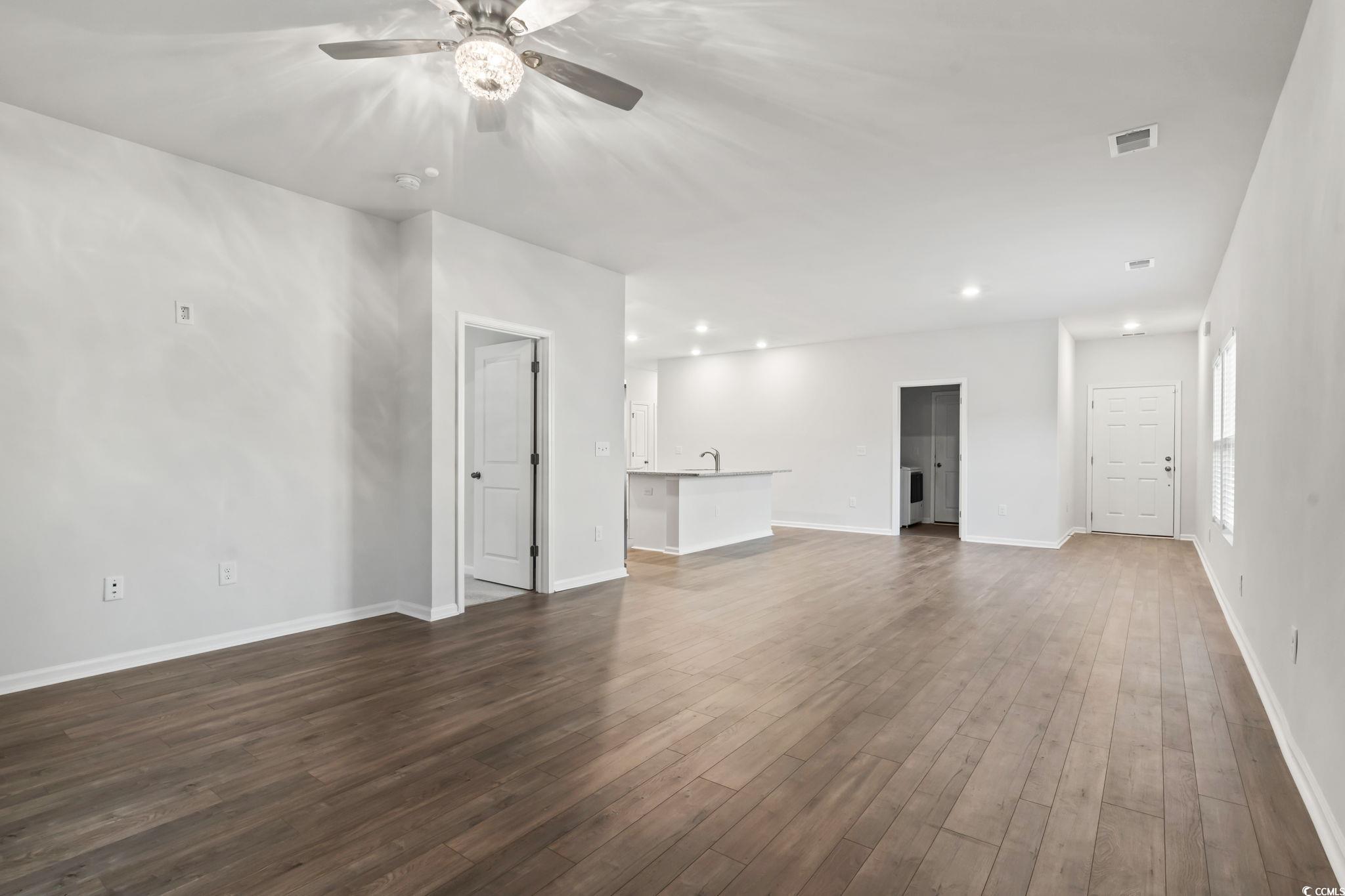 229 Cypress Tree Loop Longs, SC 29568 - Photo 18 of 40 Unfurnished living room featuring ceiling fan and