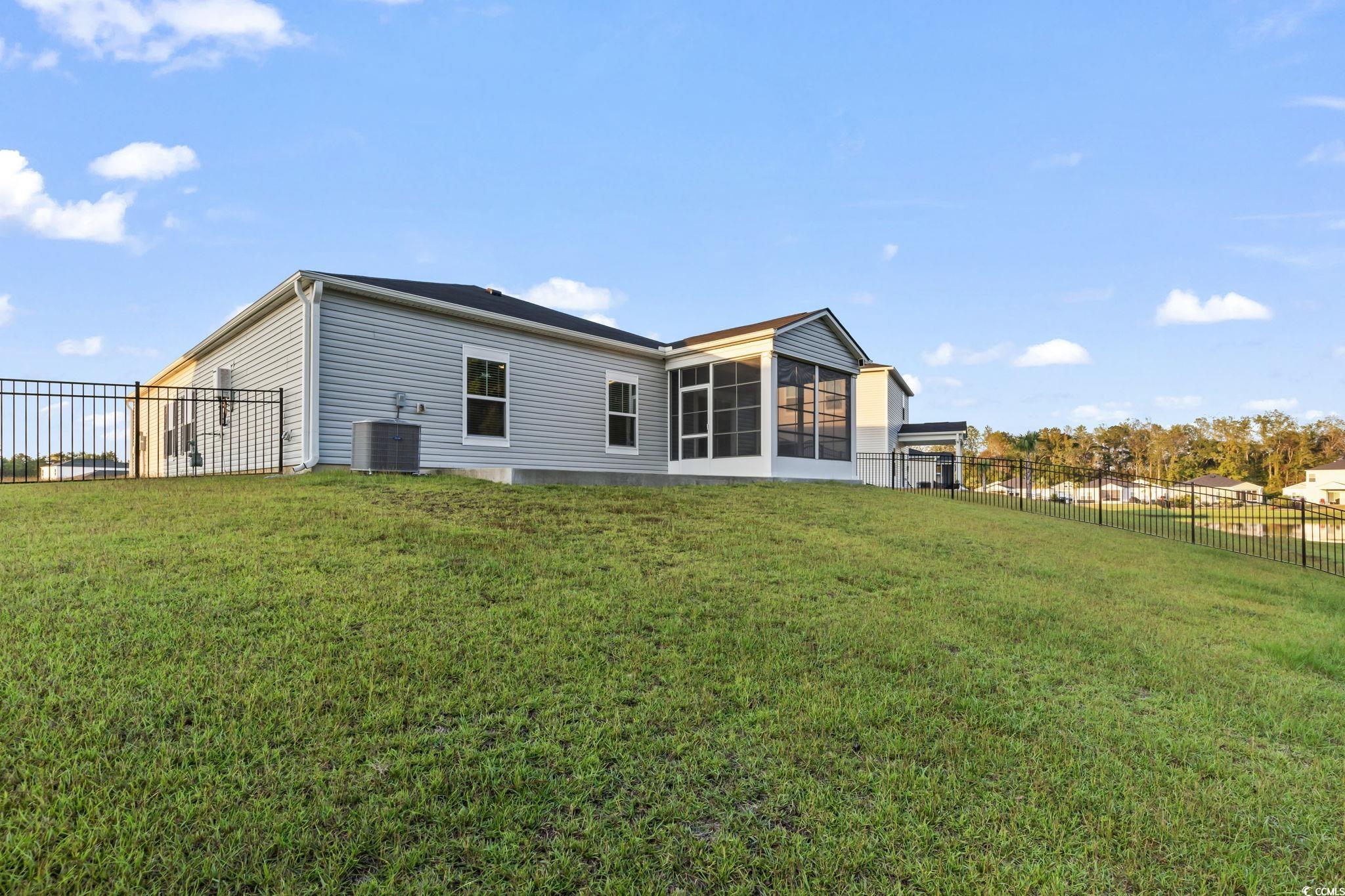 229 Cypress Tree Loop Longs, SC 29568 - Photo 30 of 40 Rear view of property featuring a sunroom, a lawn,
