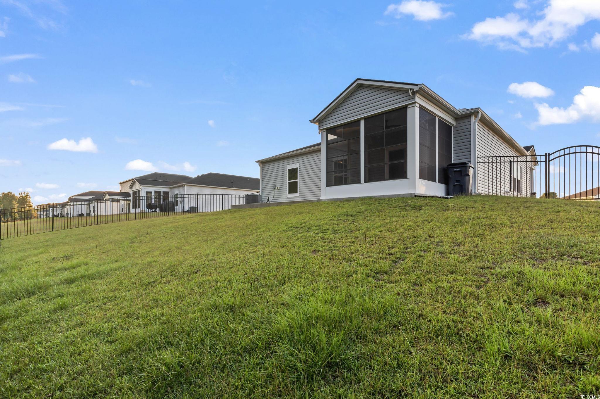 229 Cypress Tree Loop Longs, SC 29568 - Photo 31 of 40 Rear view of property featuring a sunroom and a la