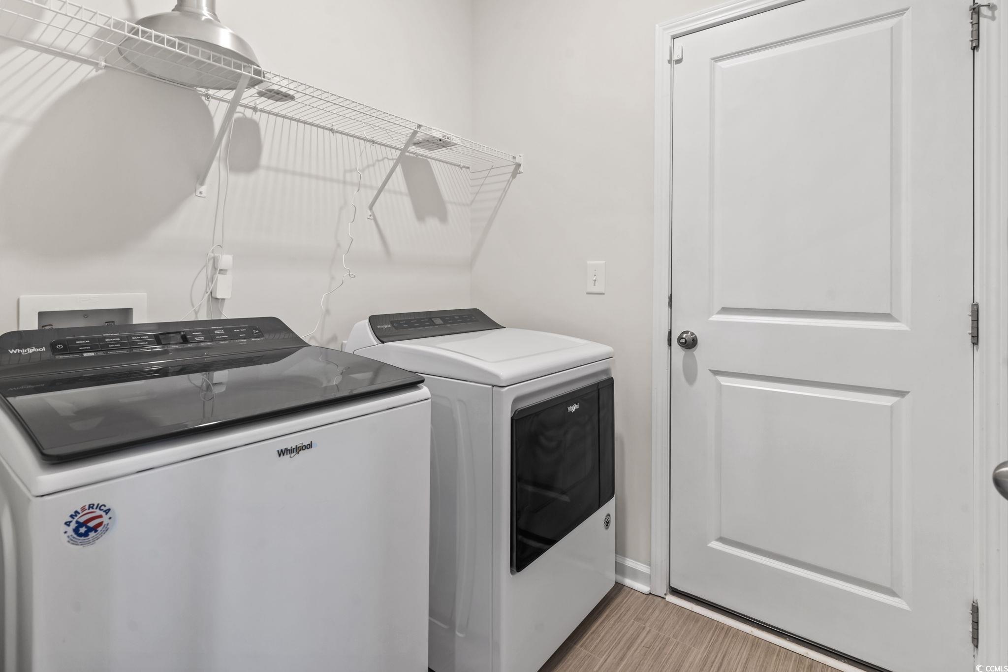 229 Cypress Tree Loop Longs, SC 29568 - Photo 4 of 40 Laundry area with light wood-type flooring and ind