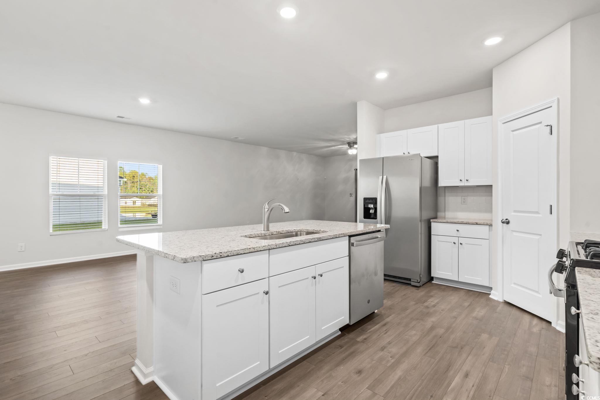 229 Cypress Tree Loop Longs, SC 29568 - Photo 8 of 40 Kitchen featuring a kitchen island with sink, wood