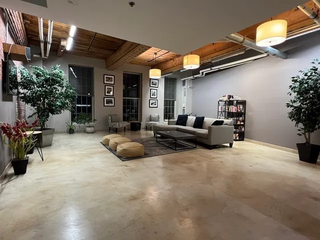 a view of the patio with couches and potted plants
