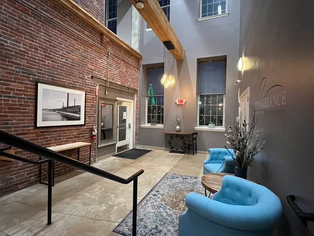 a living room with furniture potted plant and a table