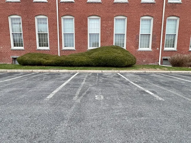 a front view of a brick house with a yard