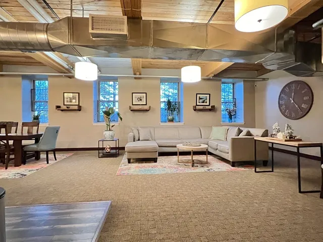 a living room with furniture and a clock