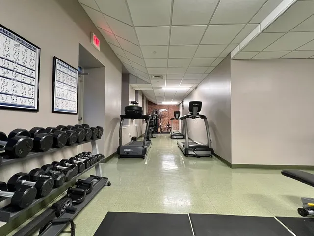 a room with gym equipment and a large window