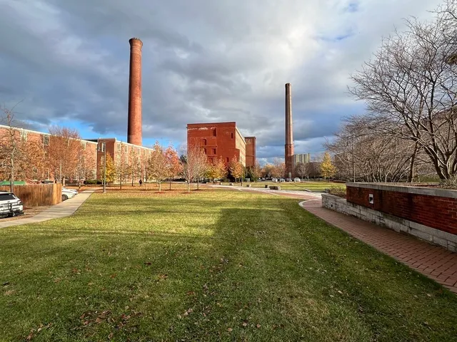 a view of a swimming pool with a yard and lawn chairs