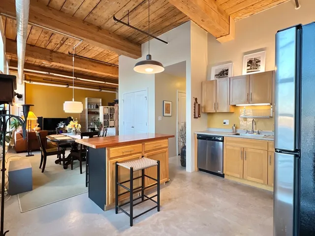 a kitchen with refrigerator cabinets dining table and chairs
