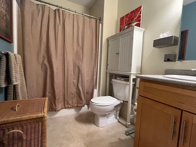a white toilet sitting next to a bathroom sink