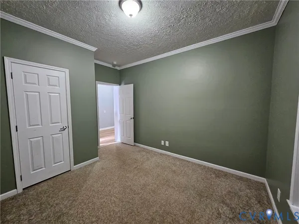 a view of a hallway with a door and couch